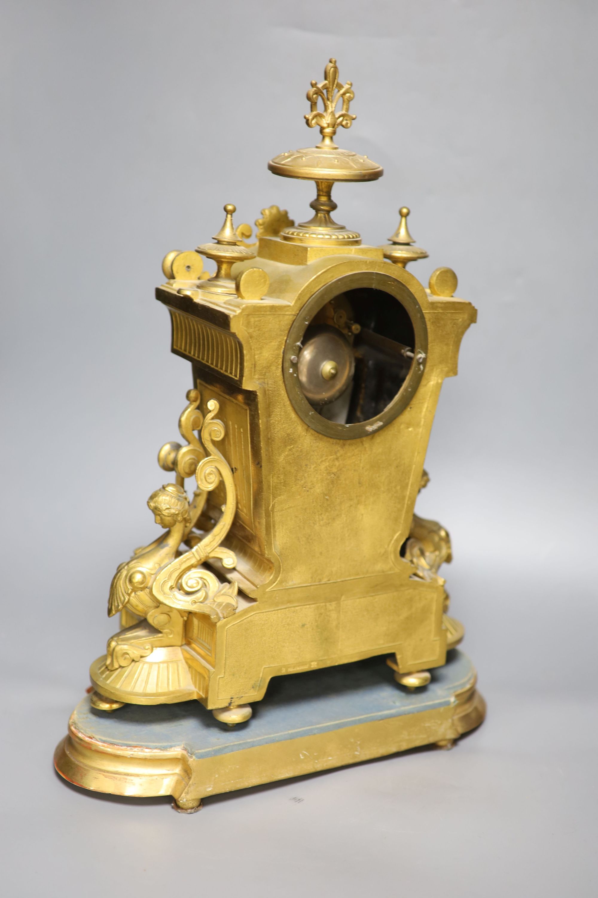 A French gilt metal and Sevres style porcelain mounted mantel clock, on plinth, with key and pendulum, overall height 49cm